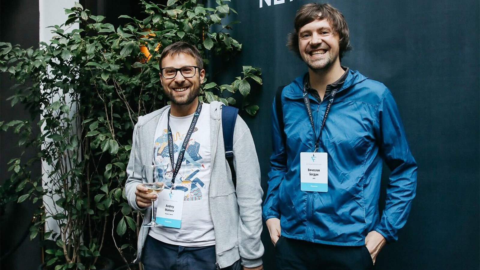 Flowwow co-founders Andrey Makeev, left, and Slava Bogdan, right, wearing name badges at a gathering