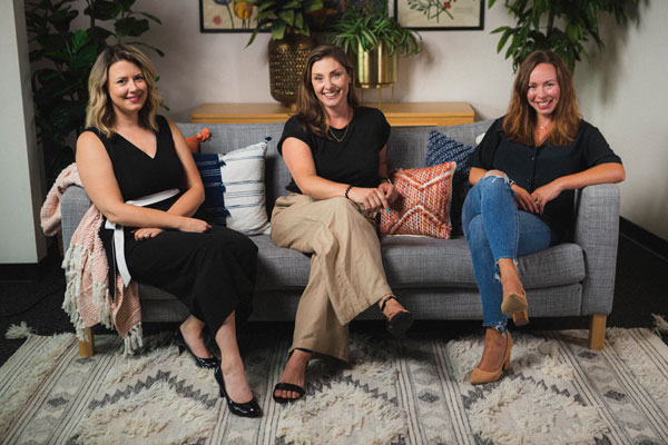 Slide Nine co-owners Whitney Somerville, Lauren Parker and Ann Mulvany seated together in the agency office