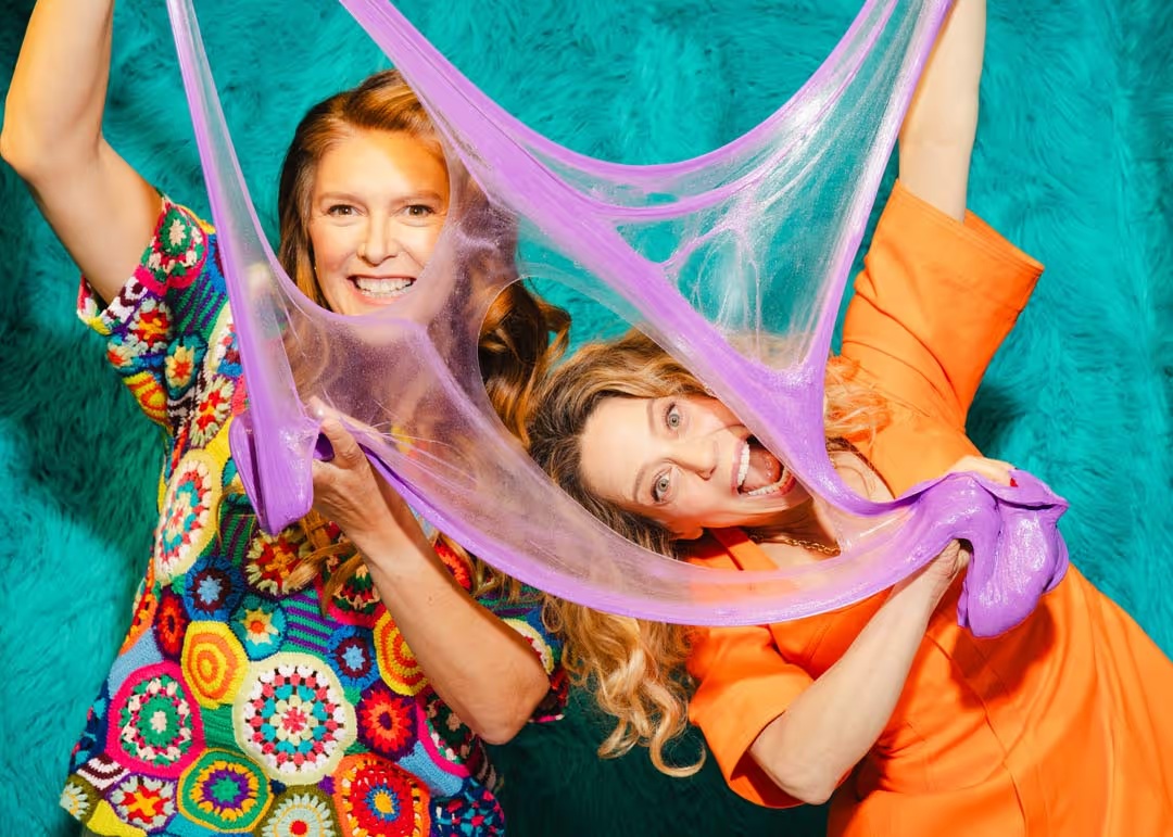 Sloomoo co-founders Karen Robinovitz and Sara Schiller playing with purple slime