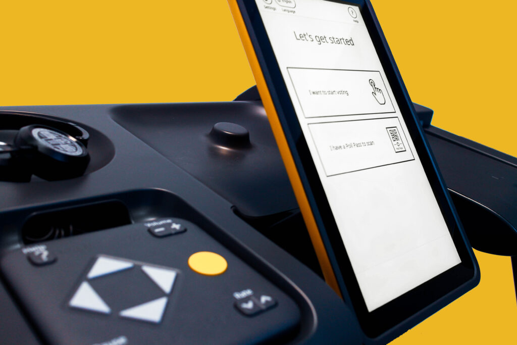 Yellow-edged VSAP touchscreen beside headphones and large tactile navigation controls