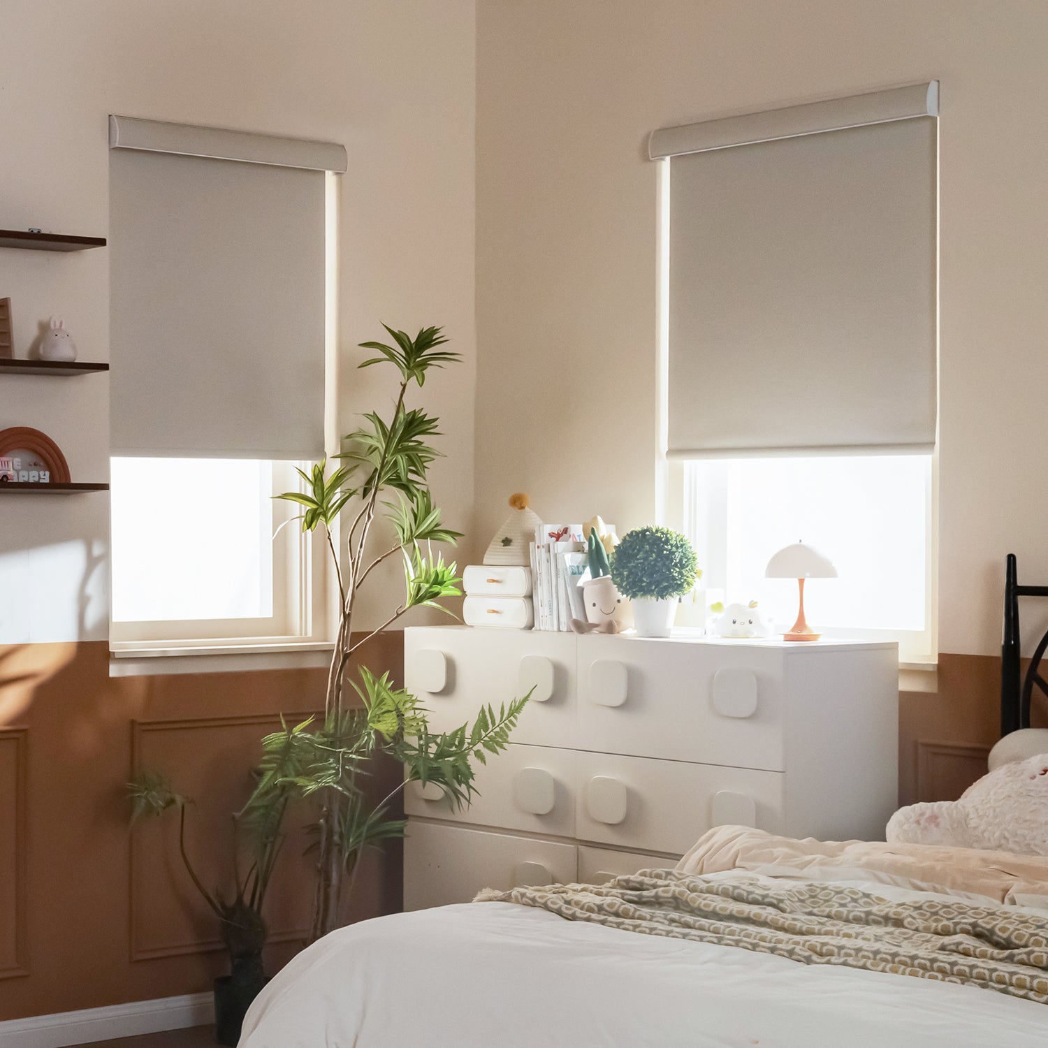 Two pale SmartWings roller shades installed over bedroom windows