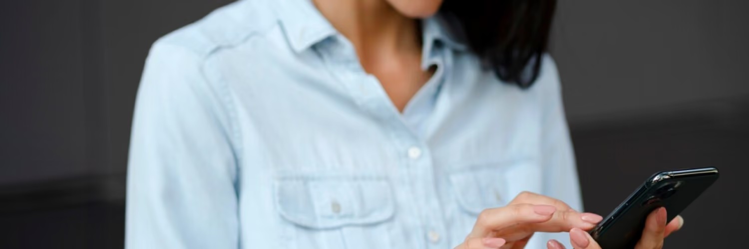 Promotional photograph of a person using a smartphone, from the SMS Assist product spotlight