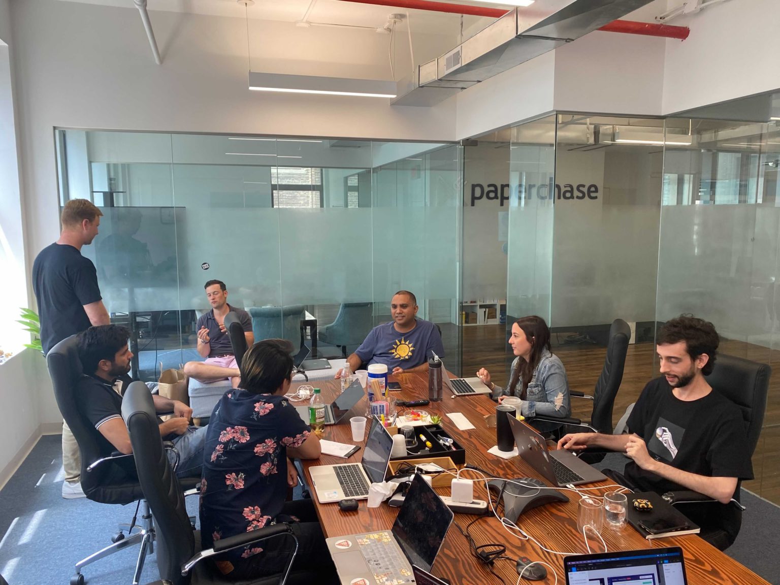 SnackMagic team members working around a table, from the company’s 2021 employee story