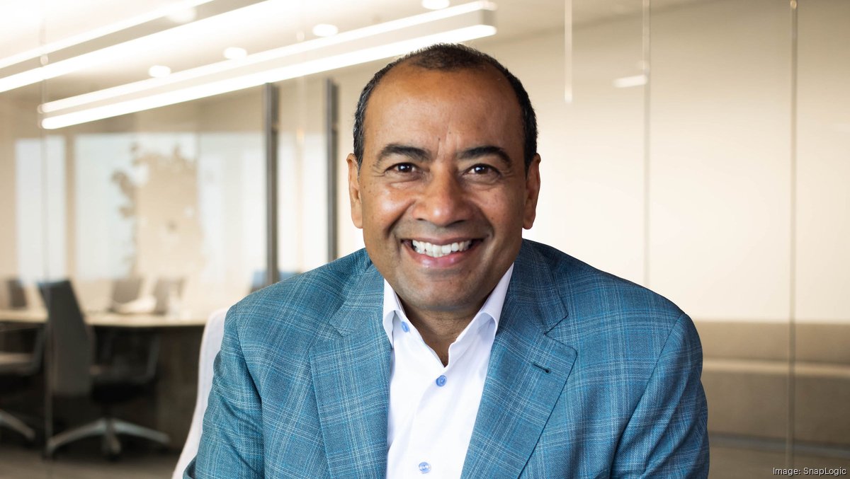 SnapLogic co-founder Gaurav Dhillon seated in a glass-walled office