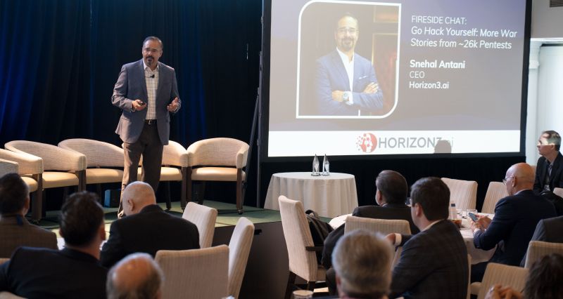 Snehal Antani speaking to an audience during a cybersecurity fireside chat