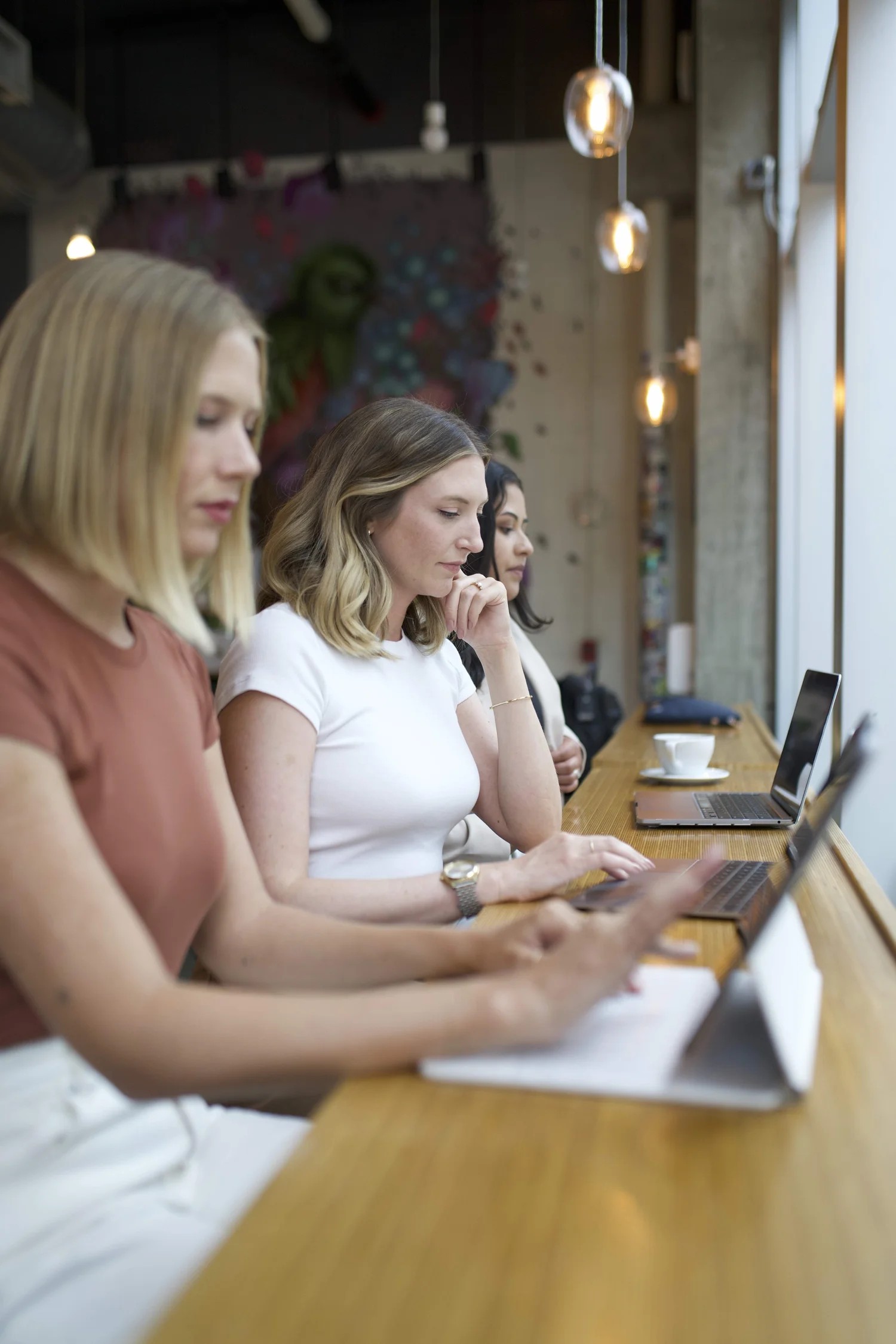Members of the Social Canvas team working side by side on laptops