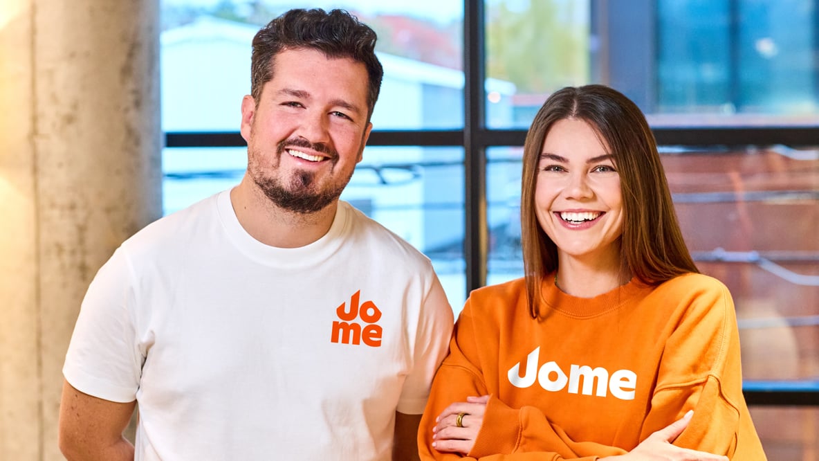 Jome co-founders Dan Hnatkovskyy and Sofia Vyshnevska wearing Jome shirts indoors