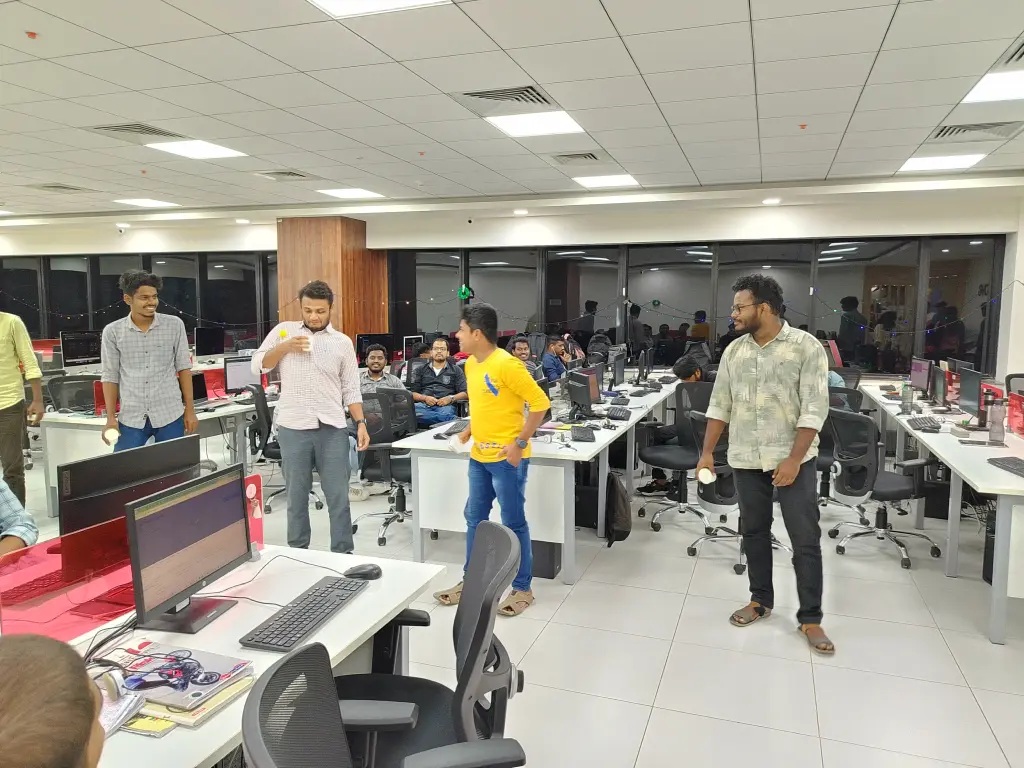 Soft Suave colleagues taking part in an office activity between rows of desks
