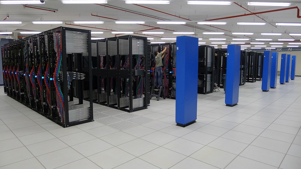 A technician works among server racks during construction of SoftLayer’s Singapore facility