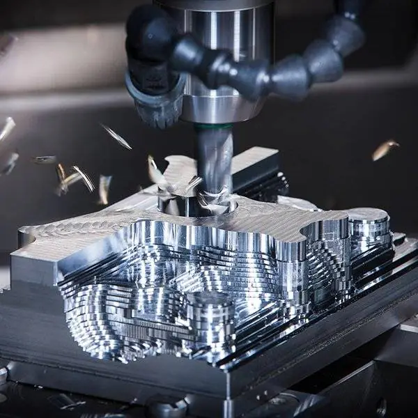 A milling cutter removing material from a metal component