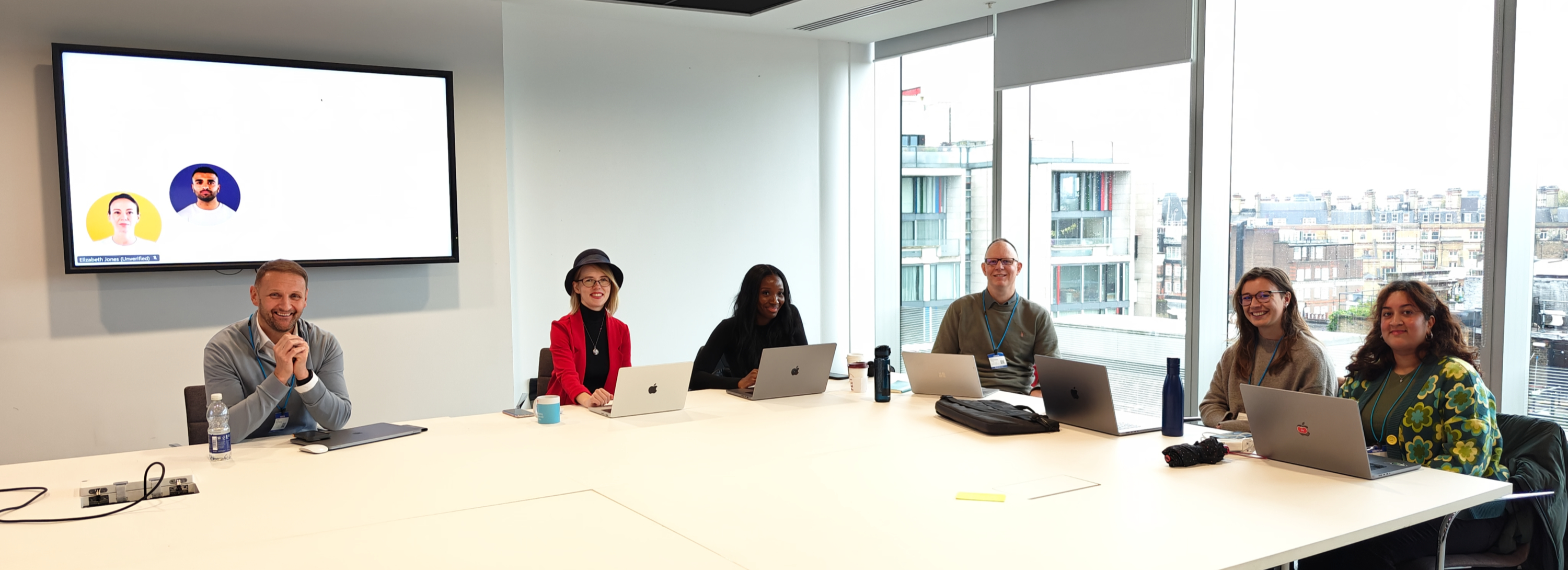 Six speakers and organisers seated with laptops at the HMCTS QA Town Hall in October 2024.