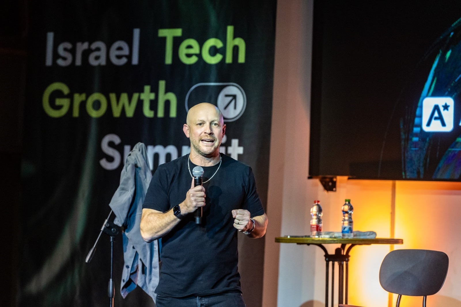 Solomon Amar speaking into a microphone at the Israel Tech Growth Summit