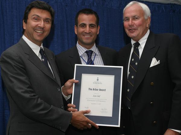 Som Seif, centre, holds his Arbor Award beside David Naylor, left, and David Peterson, right.