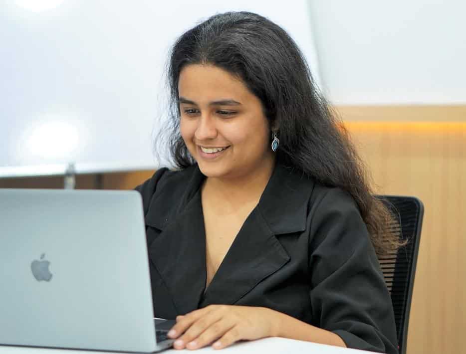 Sonakshi Nathani working at a laptop