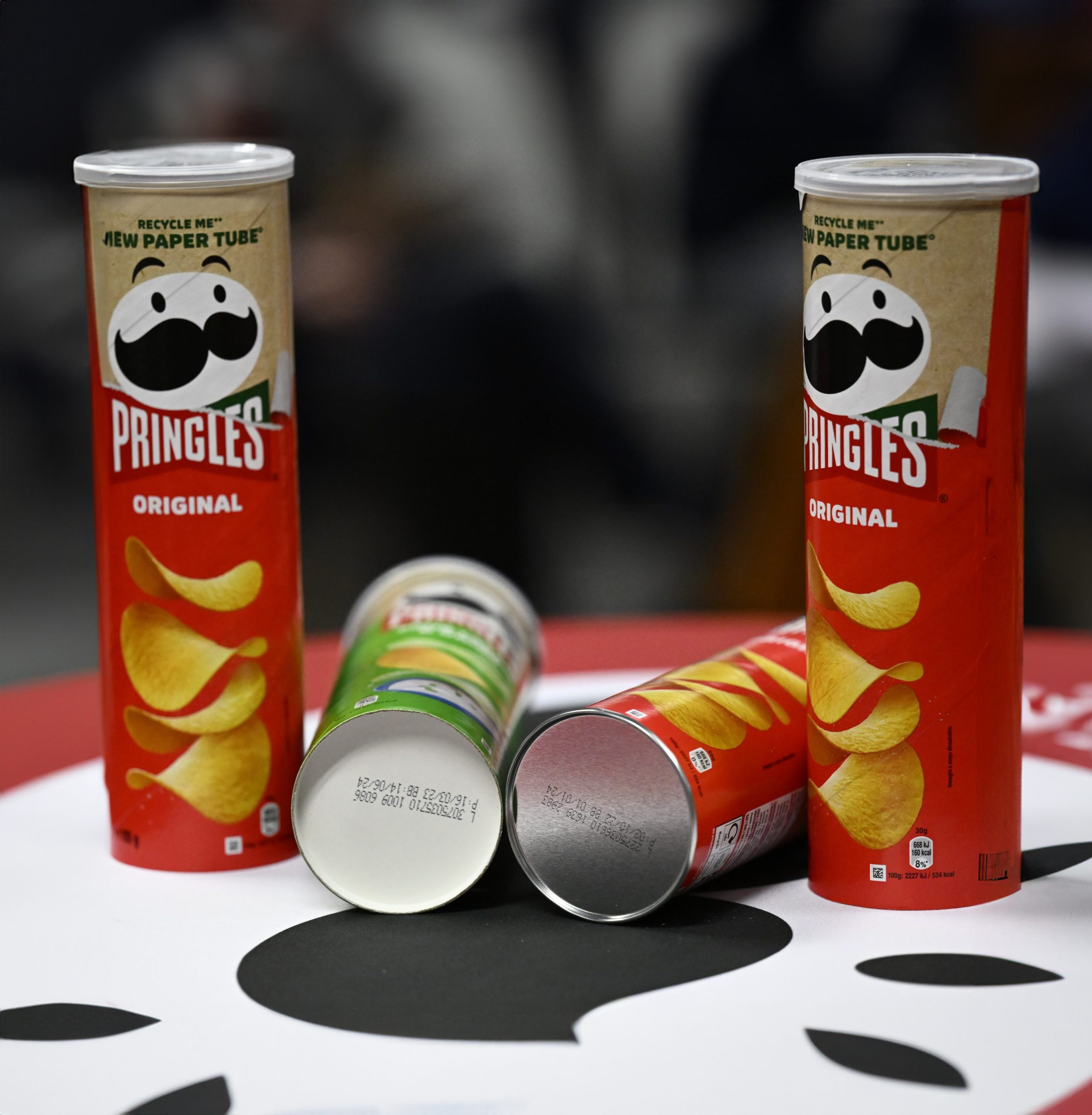 Pringles tubes showing paper and metal bottom designs side by side