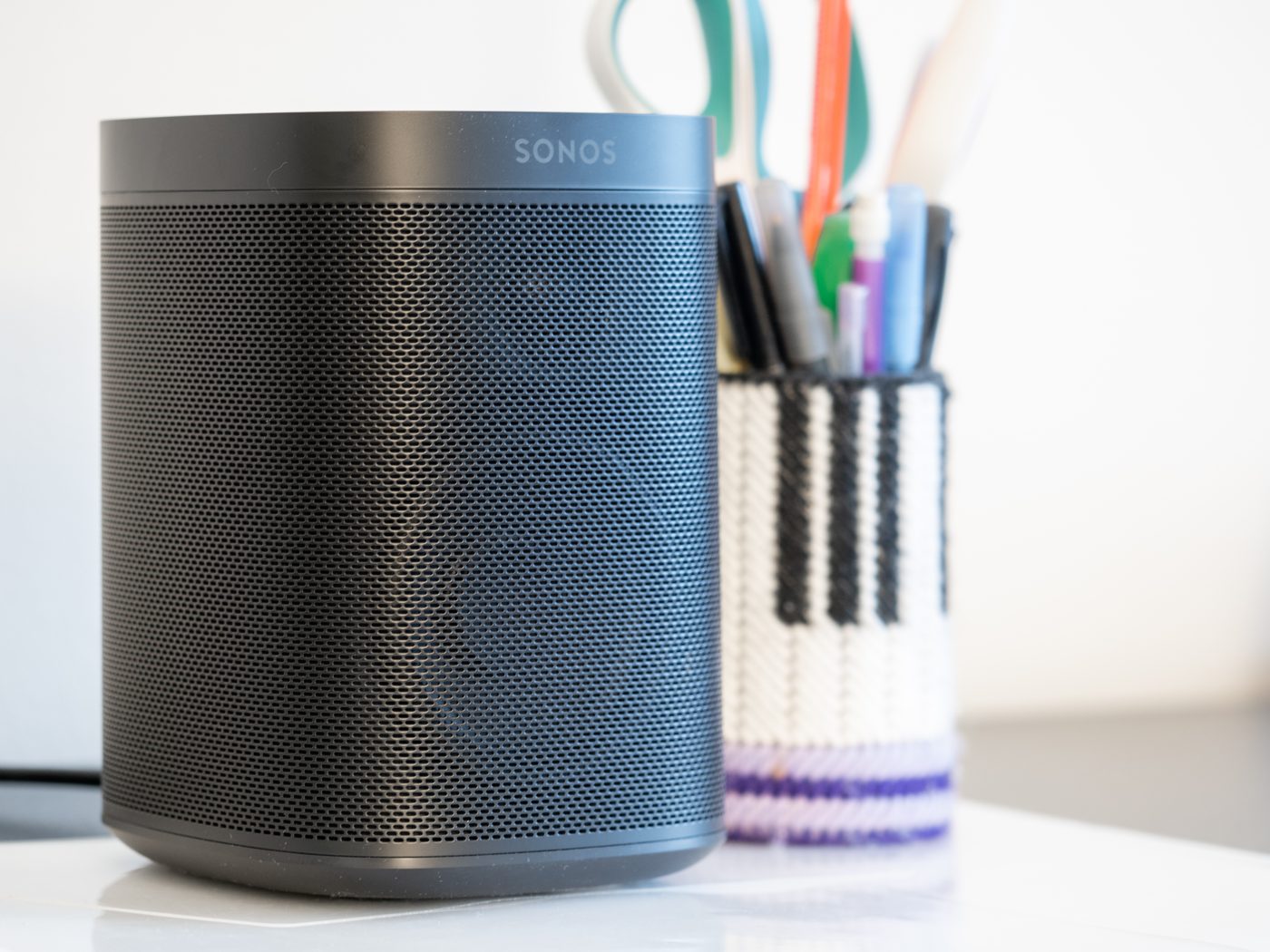A Sonos wireless speaker on a shelf at home