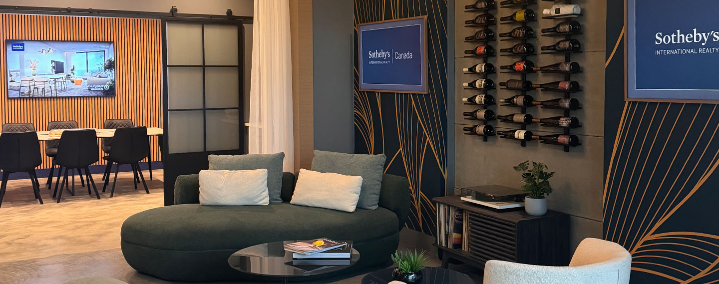 Interior of Sotheby's International Realty Canada's Kelowna office with meeting areas, property displays and branded walls