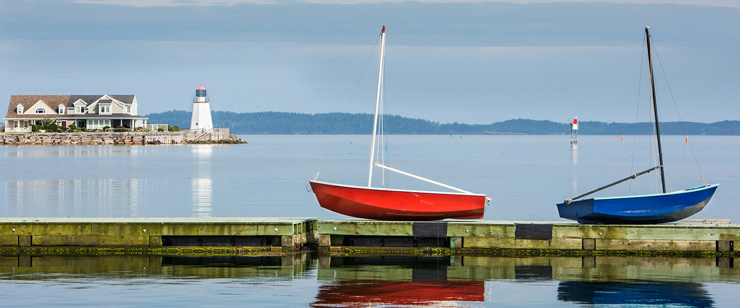 Two small sailboats at a calm harbour in St. Andrews, New Brunswick