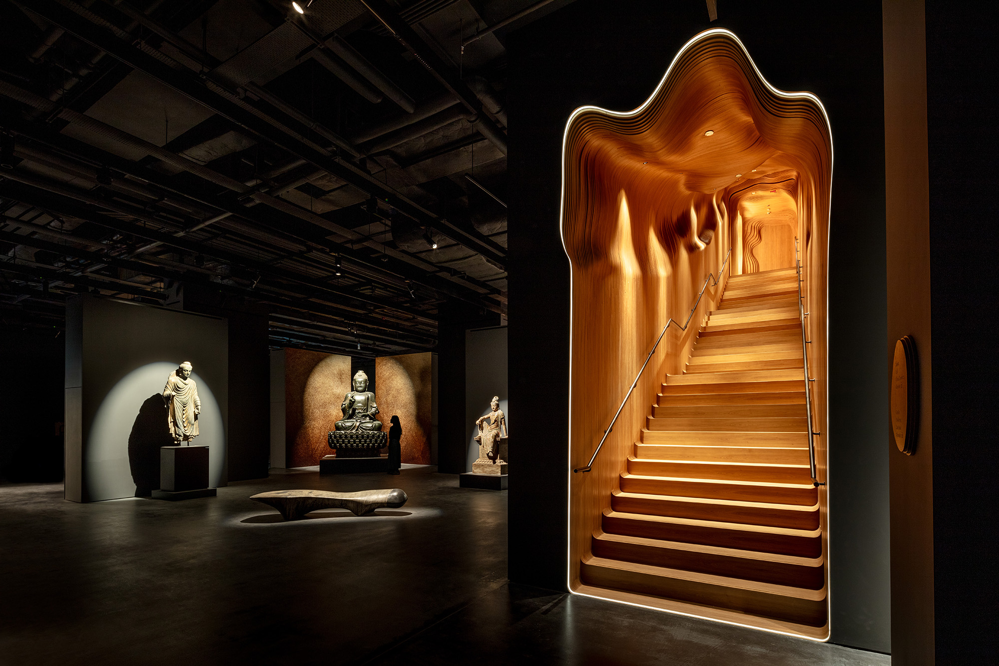 The sculptural interior of Sotheby’s Maison in Hong Kong, with illuminated stairs and dark exhibition spaces