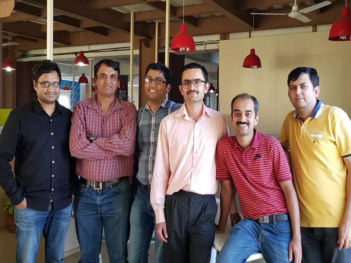 The six LightMetrics founders standing together in an office, with Soumik Ukil at the left