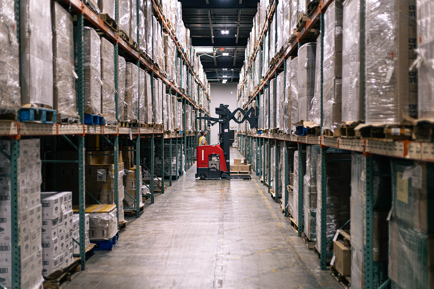 Pallet racks and a stand-up forklift inside a Source Logistics New Jersey warehouse
