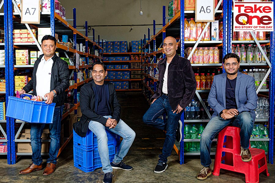 DealShare’s four co-founders in a grocery warehouse, with Medda seated second from left
