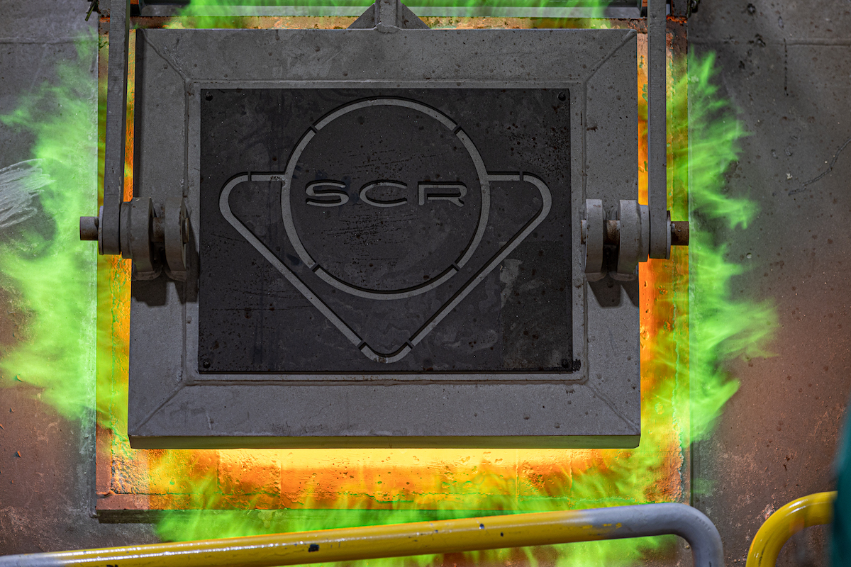 The SCR-marked furnace door glows green and orange during the start-up of Southwire’s new copper rod plant