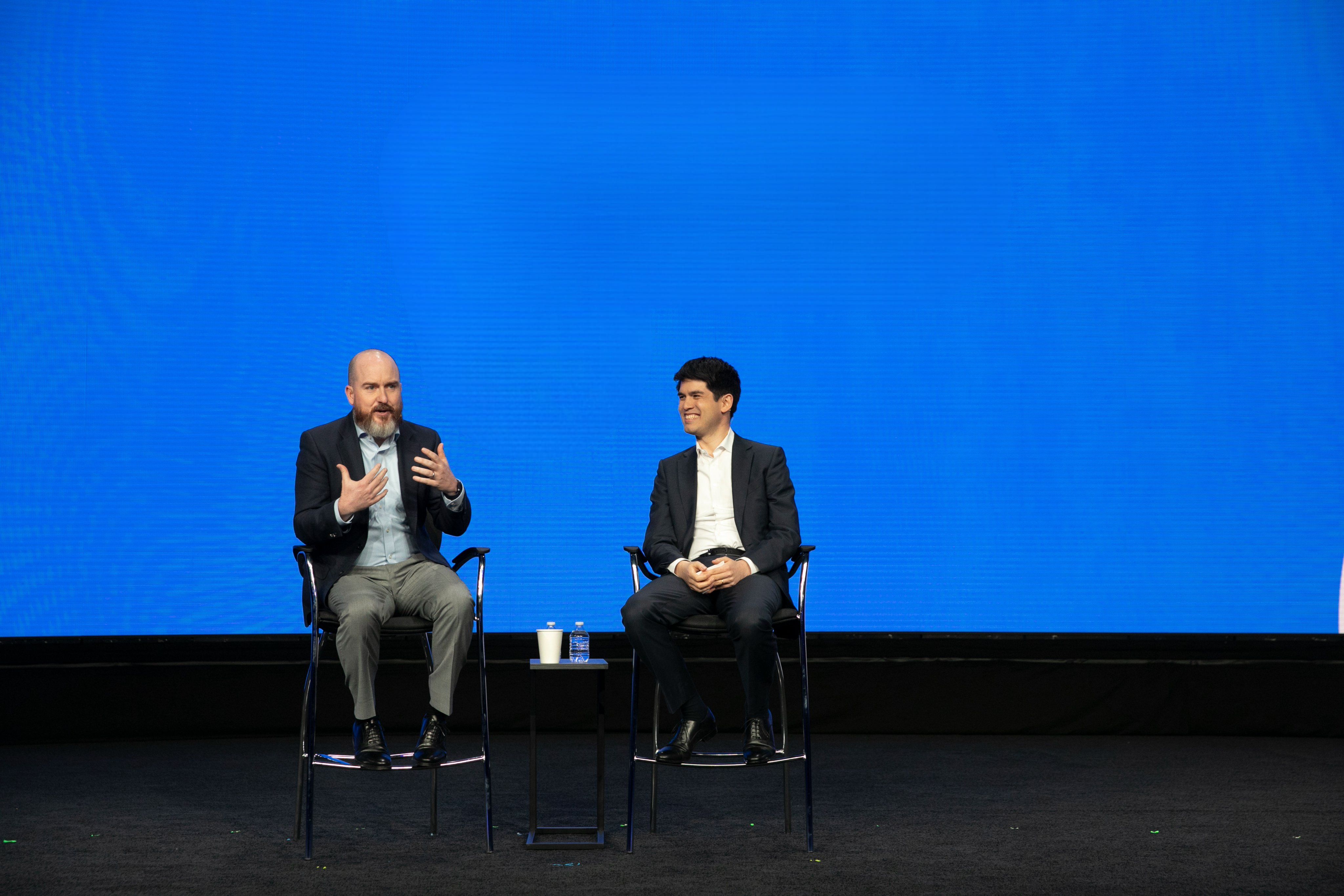 Sam Hinkie, left, and Spenser Skates, right, seated in conversation onstage at Amplify 2022