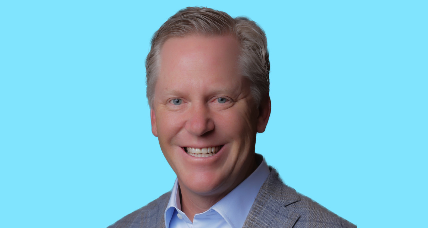 Matt Stava, founder and CEO of Spinnaker Support, in a gray jacket against a blue background