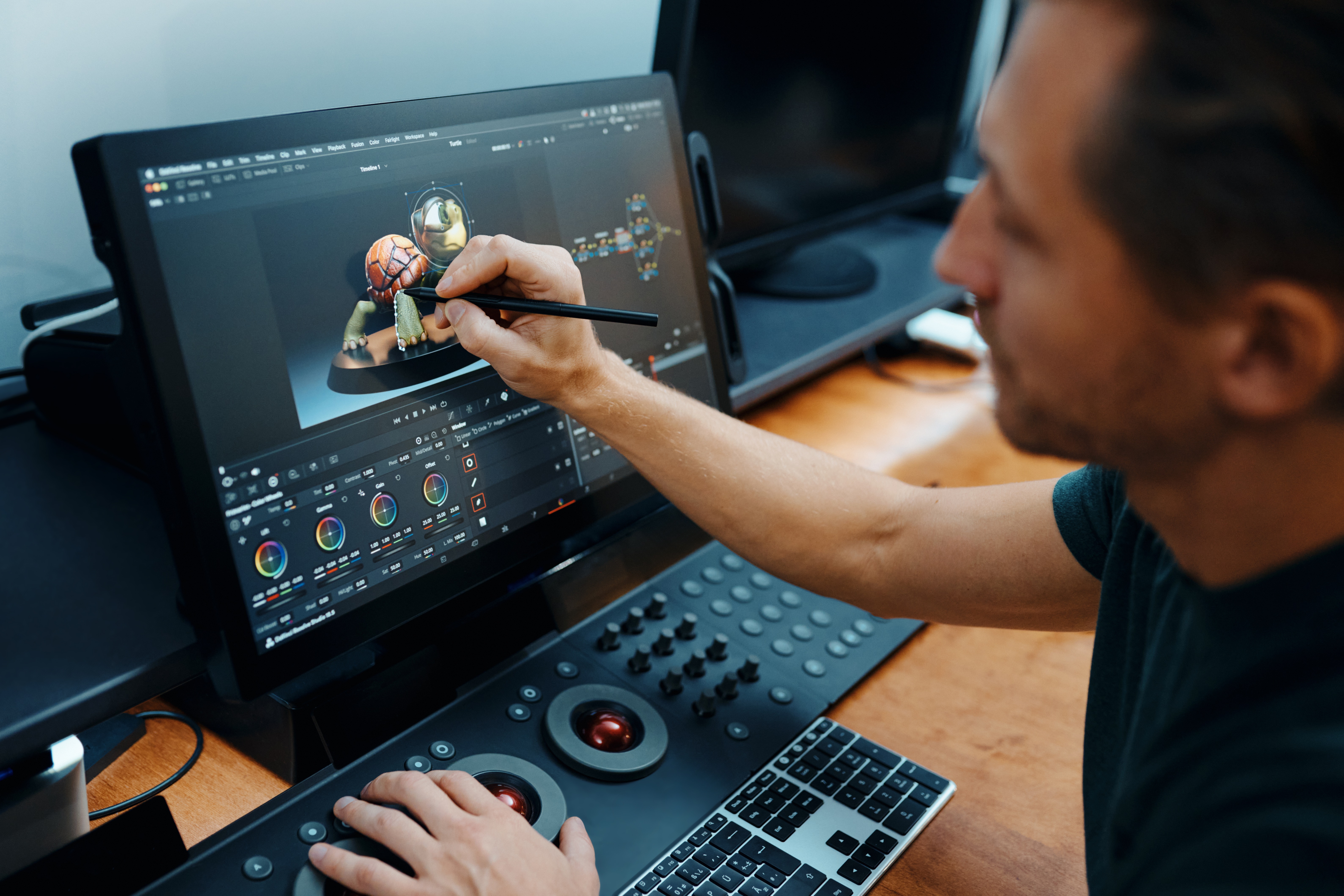A creative professional working at a Wacom Cintiq Pro display and workstation