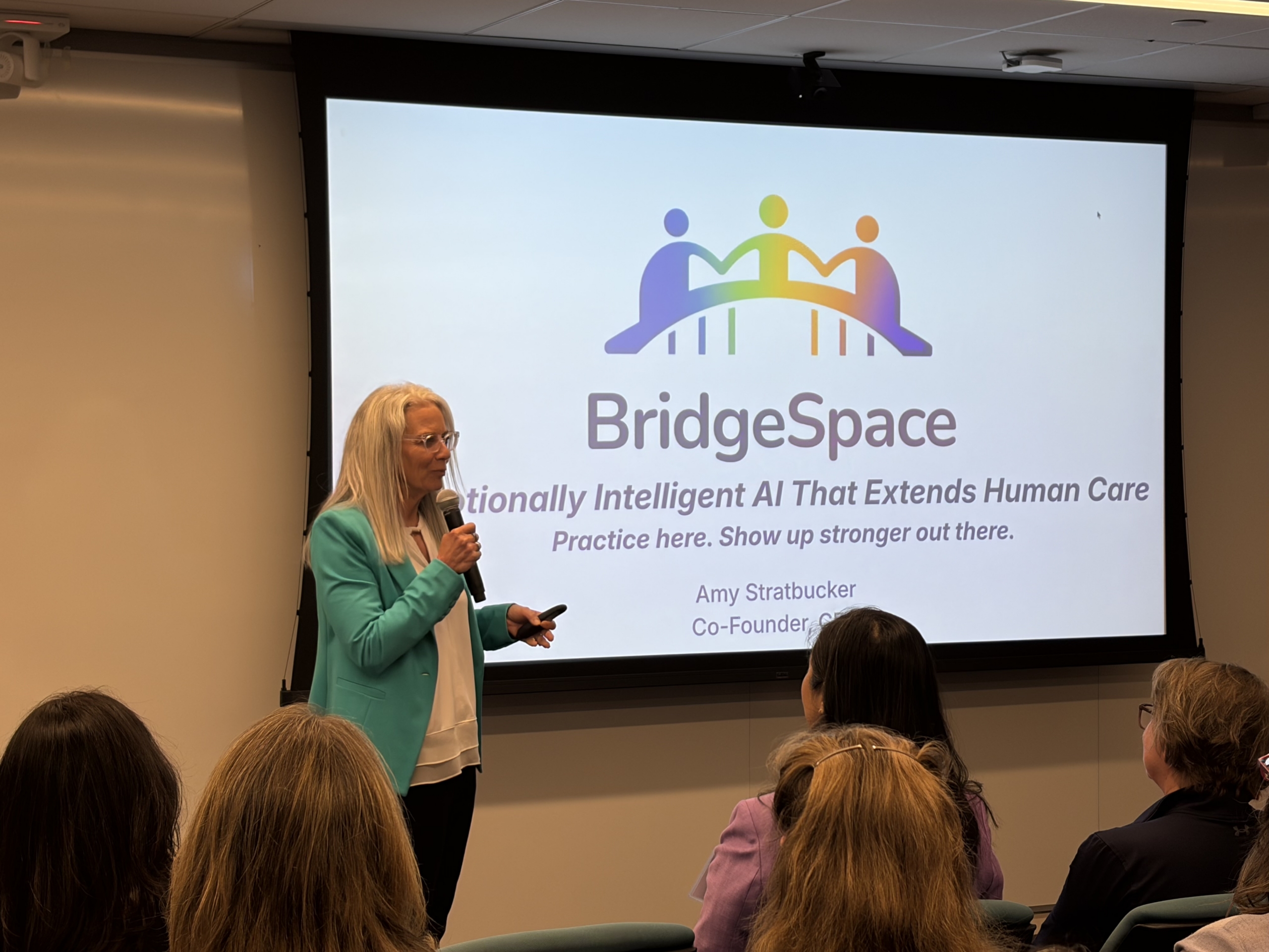 BridgeSpace co-founder Amy Stratbucker presents to an audience at Springboard's 2026 Washington-area Dolphin Tank