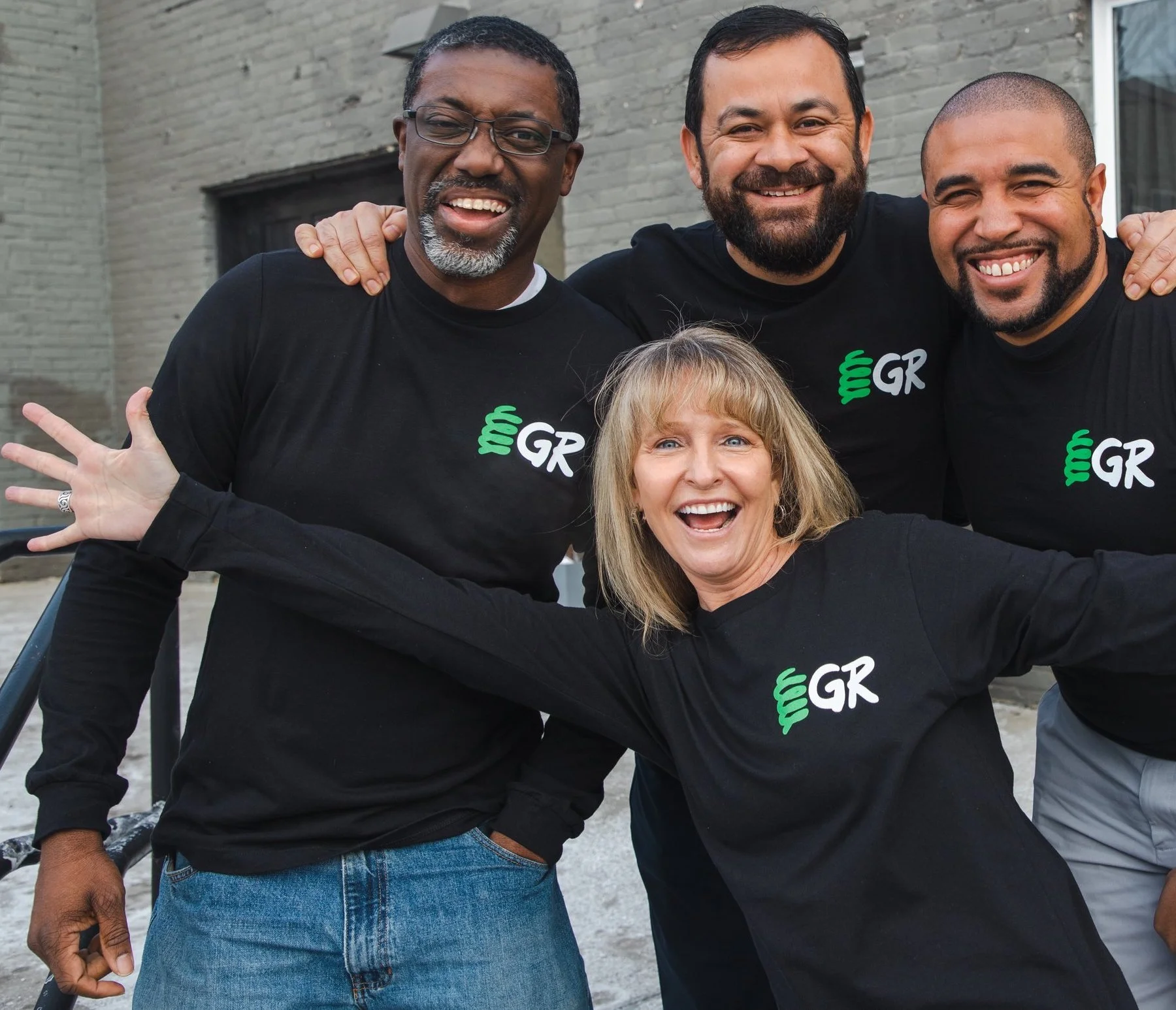 Four members of SpringGR’s team pose together in matching black SpringGR shirts