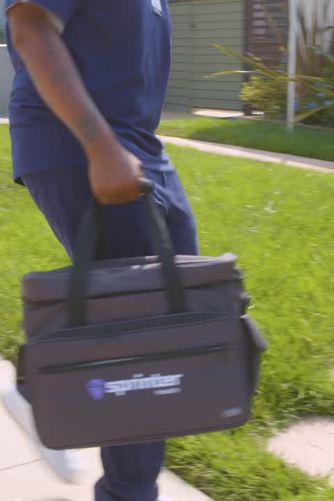 A Sprinter Health clinician walking with a medical equipment bag