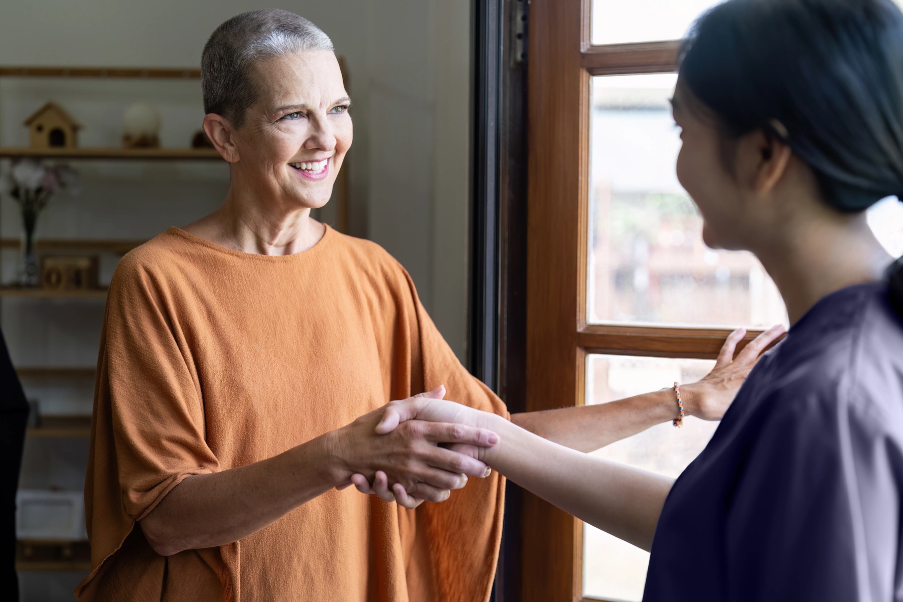 A Sprinter Health clinician greeting a patient at her front door