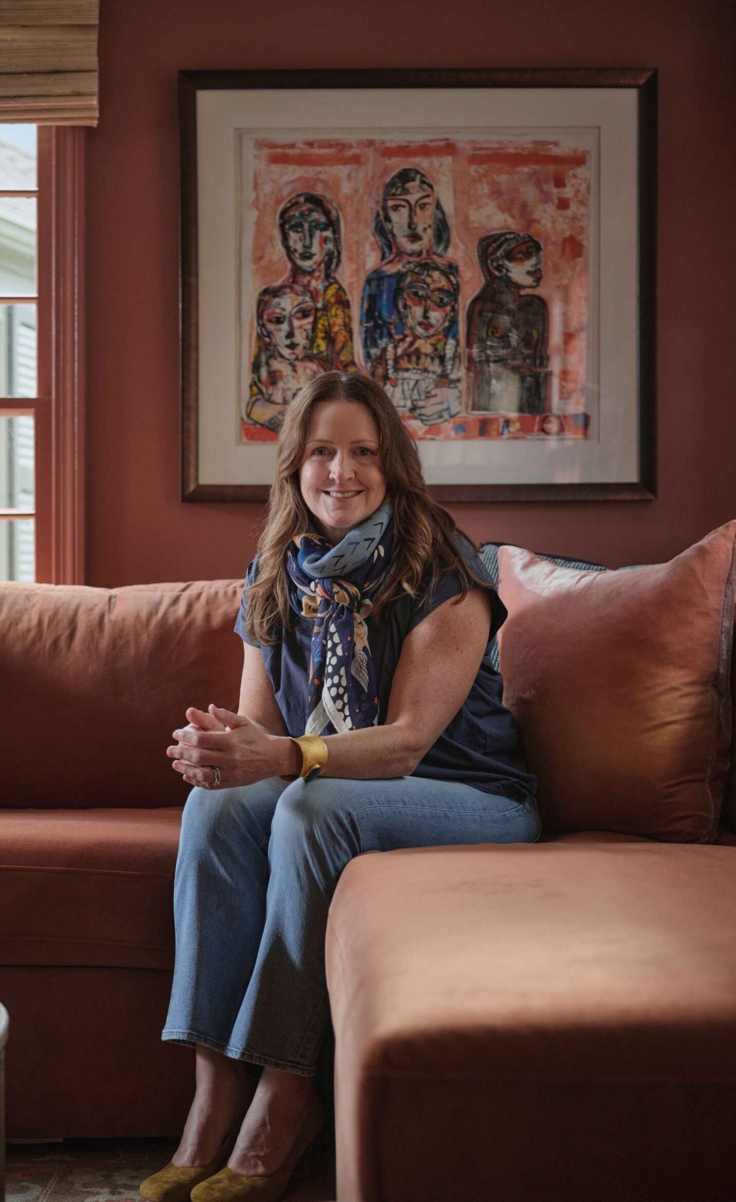 Sprouthouse founder Melany Robinson seated in a warm, art-filled room