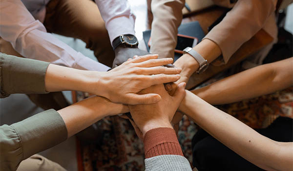 Hands stacked together in an image used on SproutLoud’s careers page
