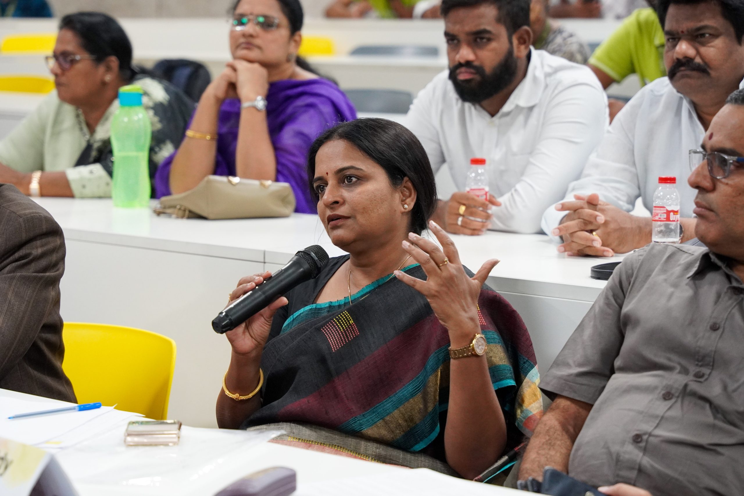 Sreedevi Devireddy speaking into a microphone during SRM University-AP’s Entrepreneurship Bootcamp Demo Day