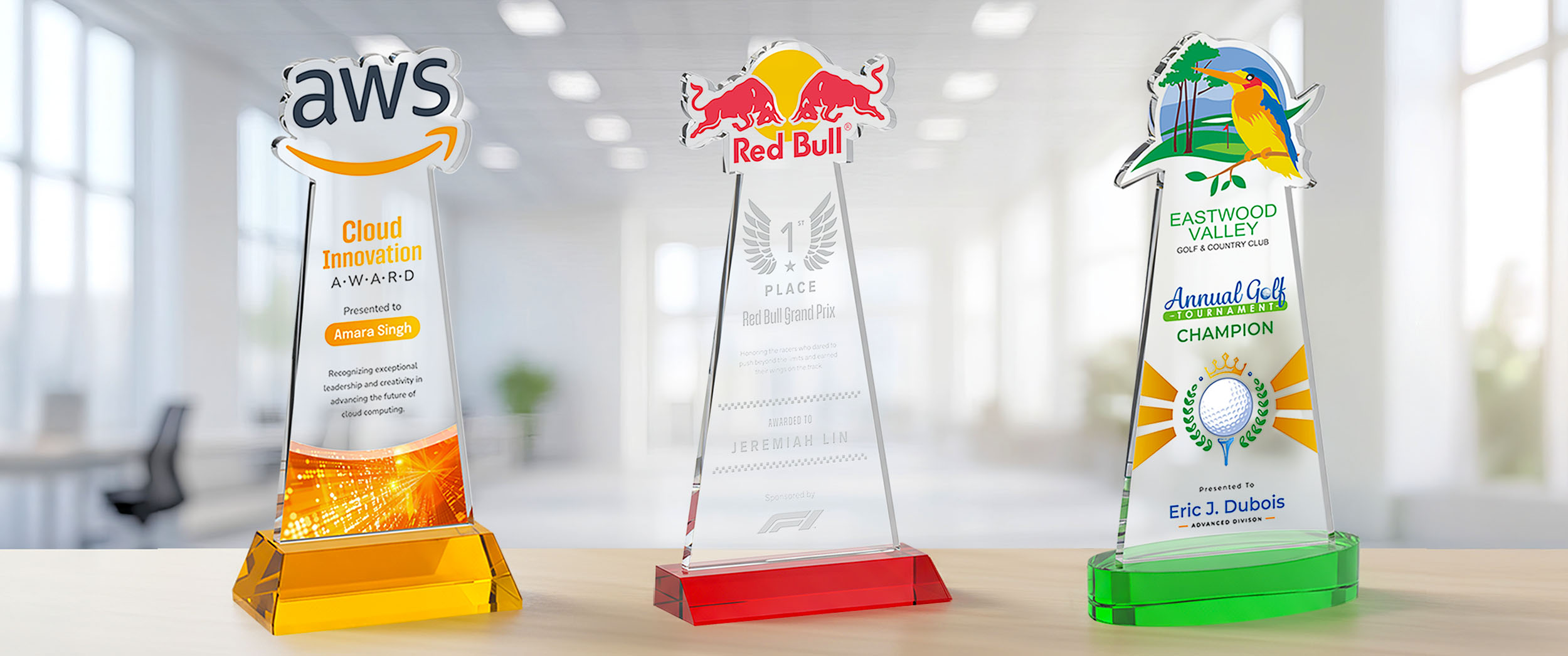 Three custom EdgeCraft crystal awards with colorful brand-shaped tops