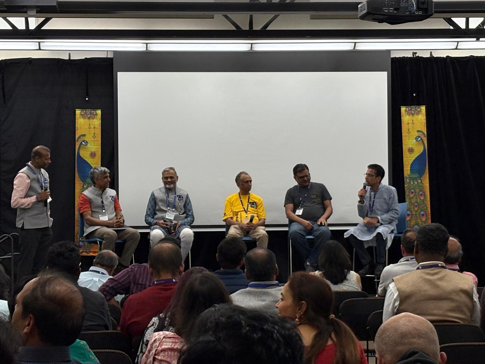 Srikanth Konda, seated at far right, speaks on a panel with four other Sewa International USA presidents in San Francisco.