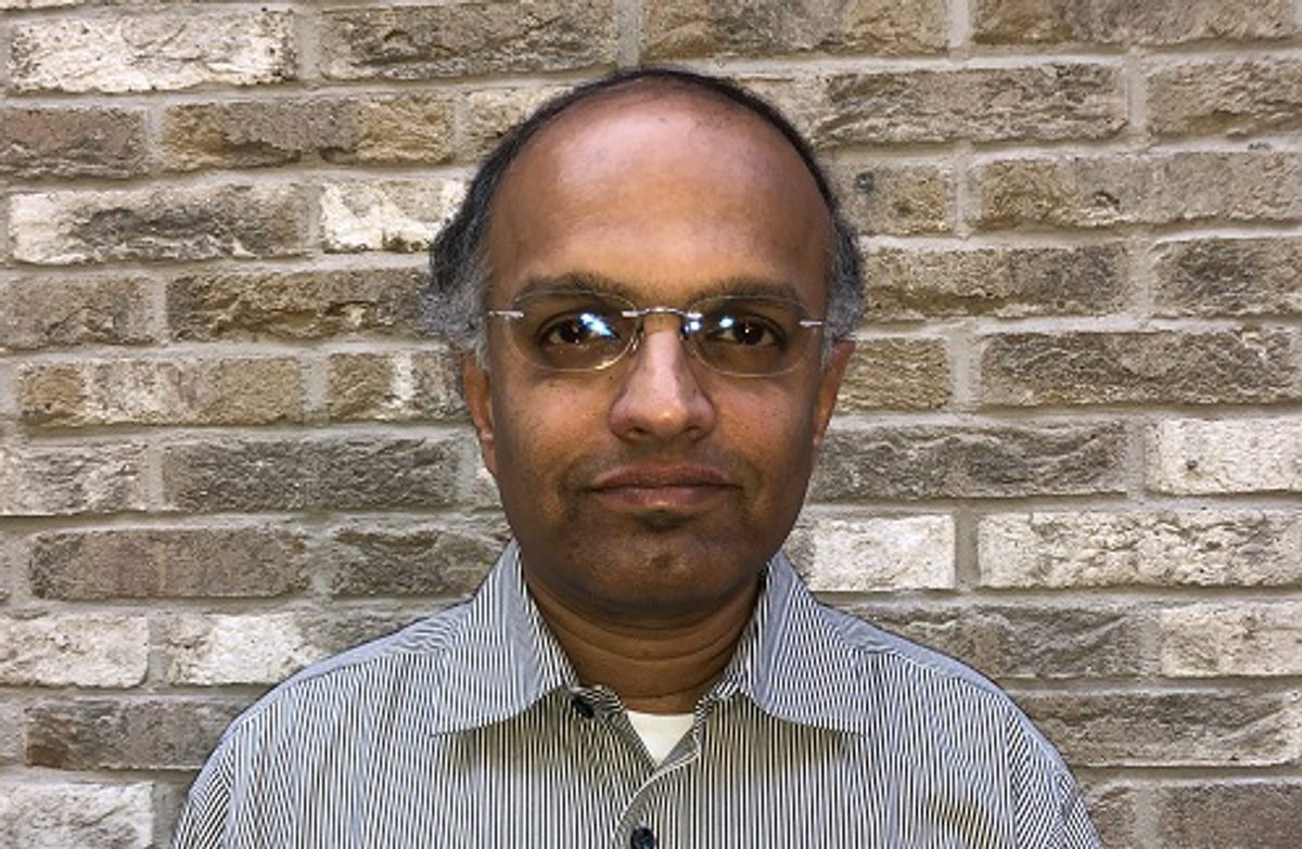 Srinivas Ramanathan in a striped shirt, photographed against a brick wall