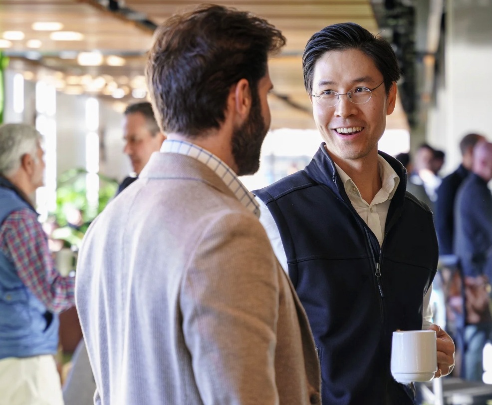 Two people in conversation at a Stage 2 Capital community gathering