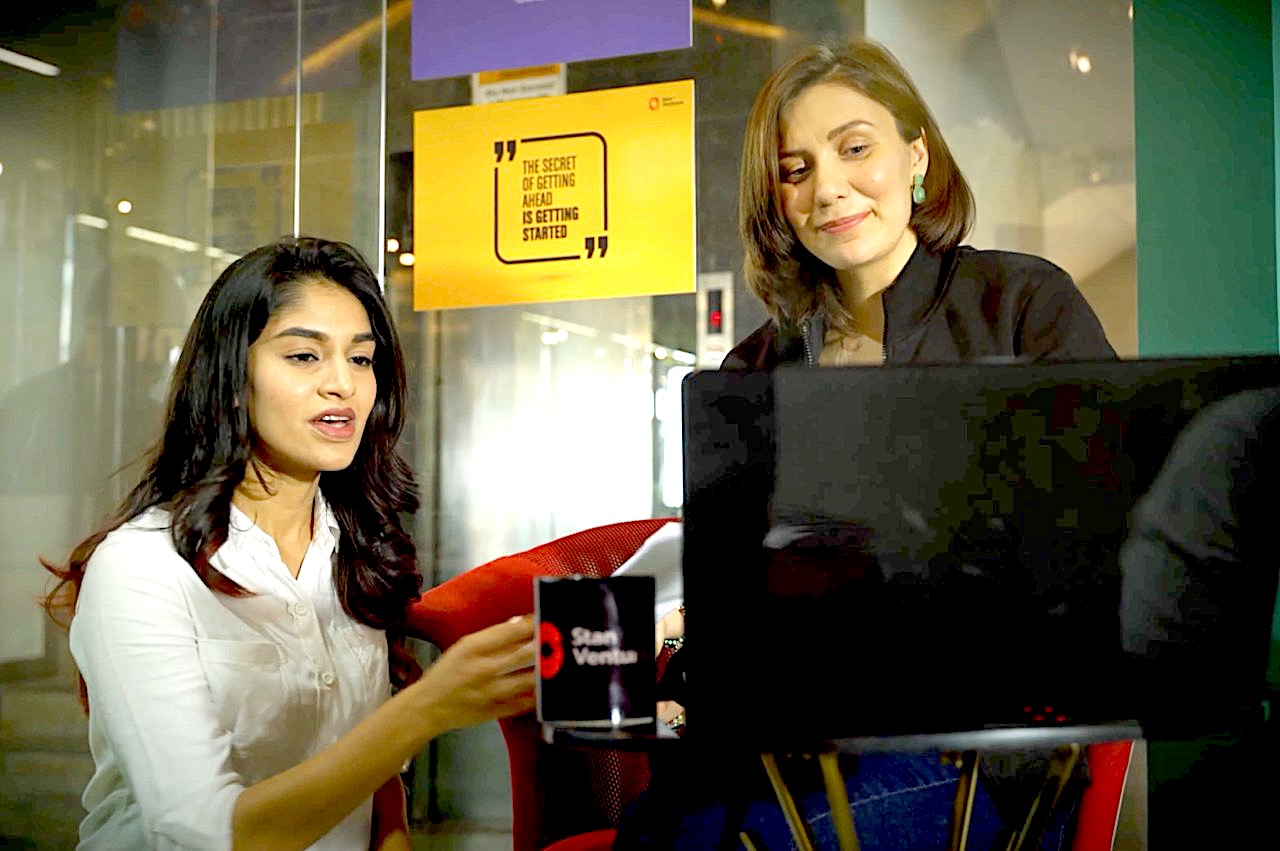 Two Stan Ventures colleagues collaborating at a computer in an office