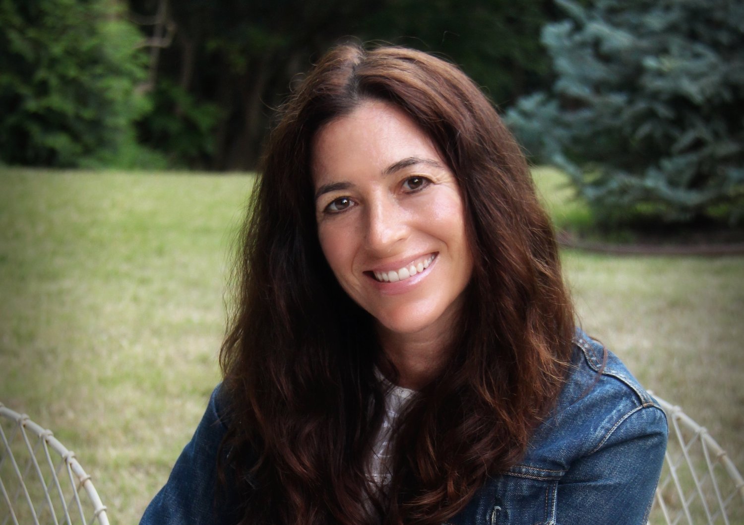 Amy Stanton, founder and CEO of Stanton and Company, seated outdoors