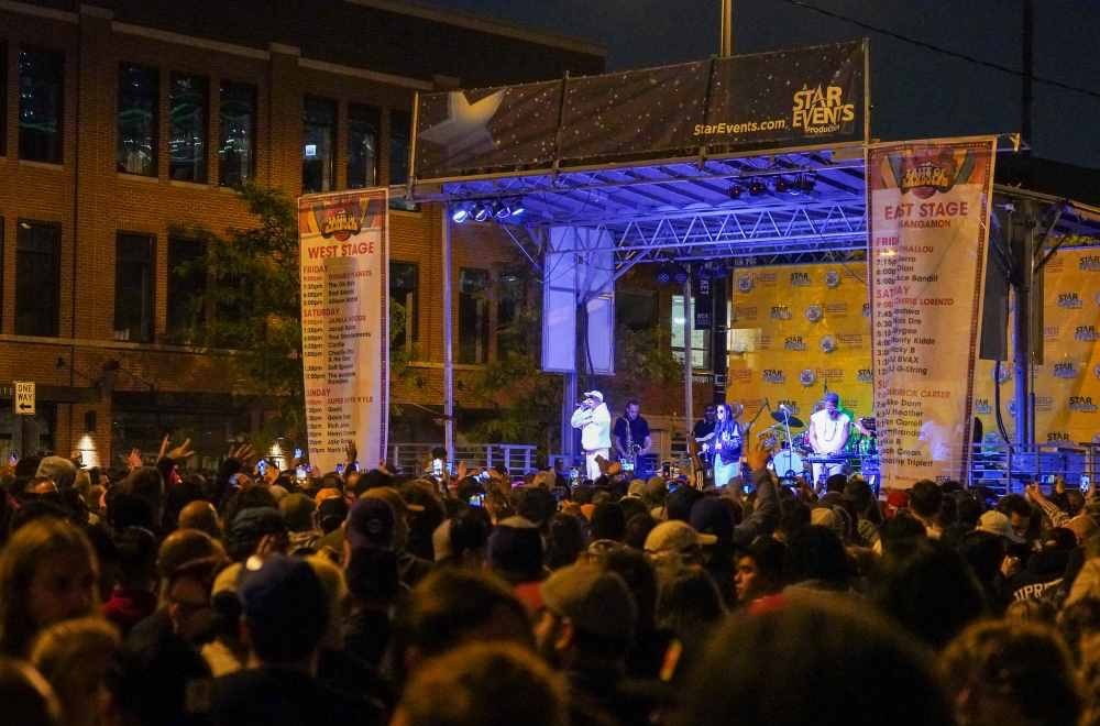 A StarEvents-produced Taste of Randolph concert stage at night, seen over a dense crowd