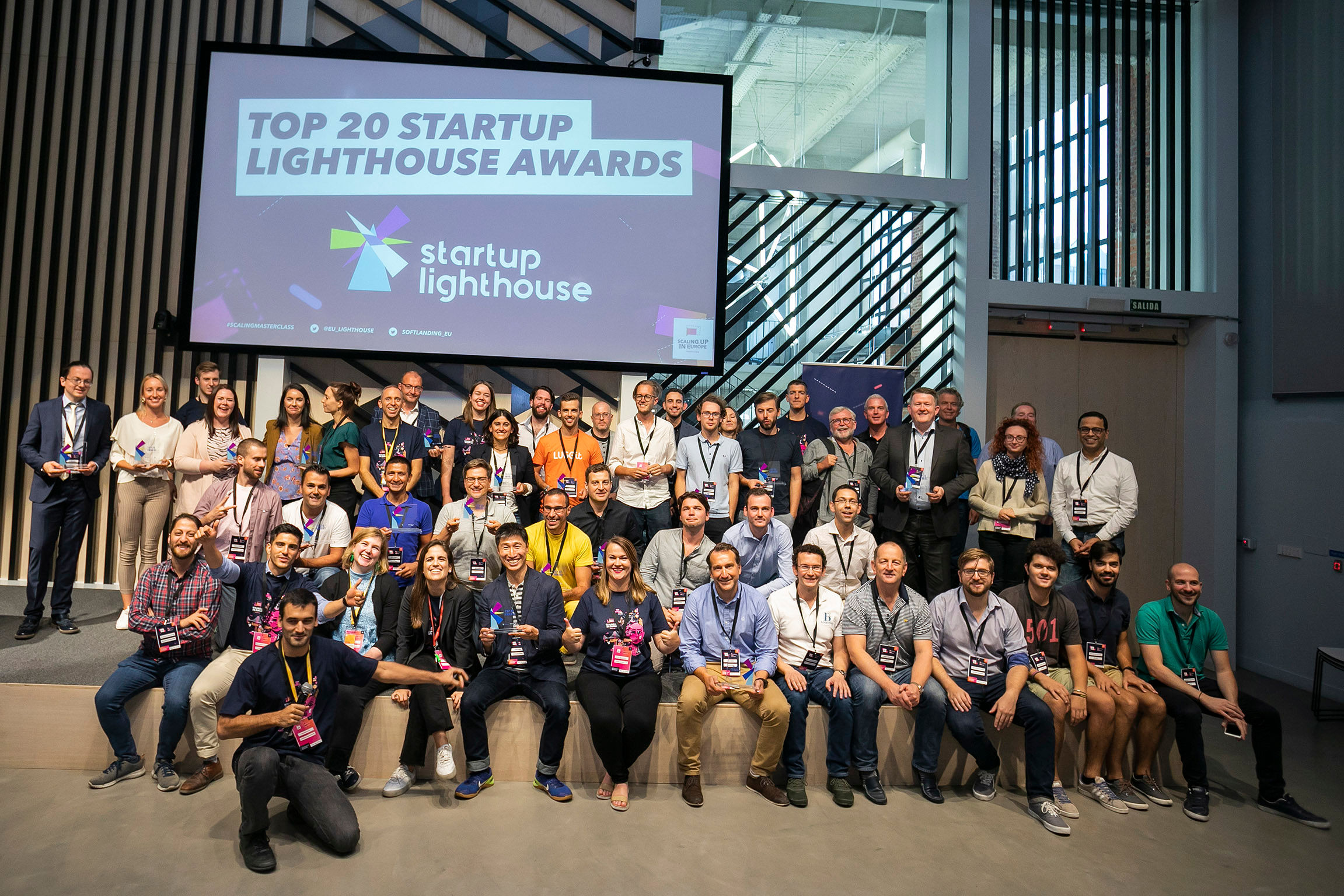 Startup Lighthouse awards participants gathered beneath a screen reading Top 20 Startup Lighthouse Awards