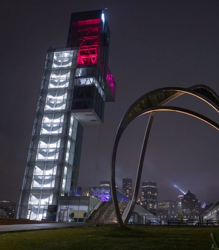 Illuminated tower and waterfront architecture at Montréal’s Grand Quai