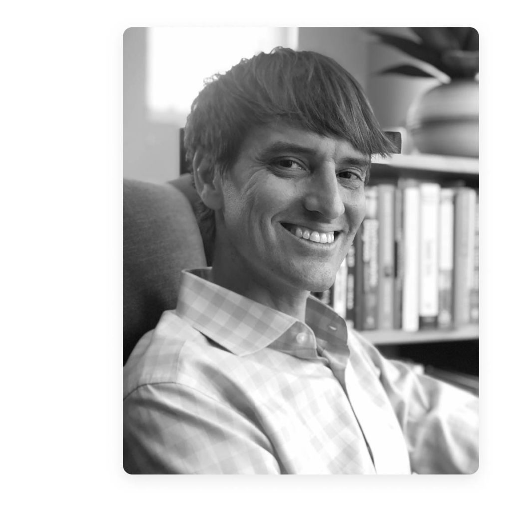 Rob Walling smiling in front of a bookshelf