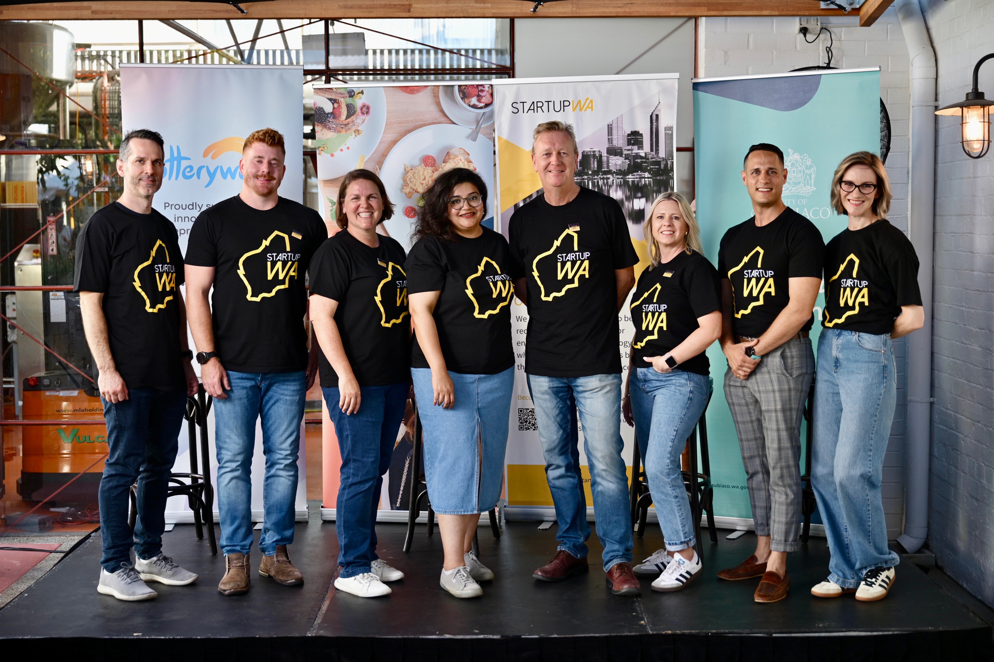 StartupWA board members pictured together in matching black Startup WA shirts