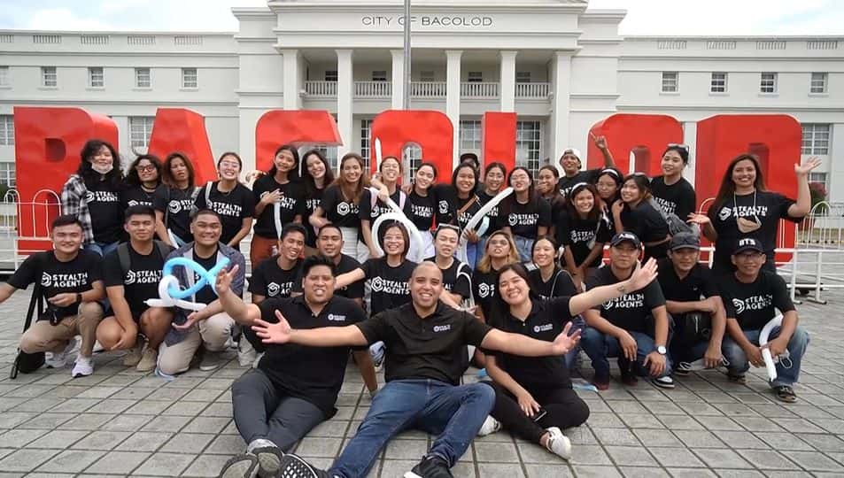Stealth Agents staff in matching black shirts gathered at the Bacolod landmark in the Philippines