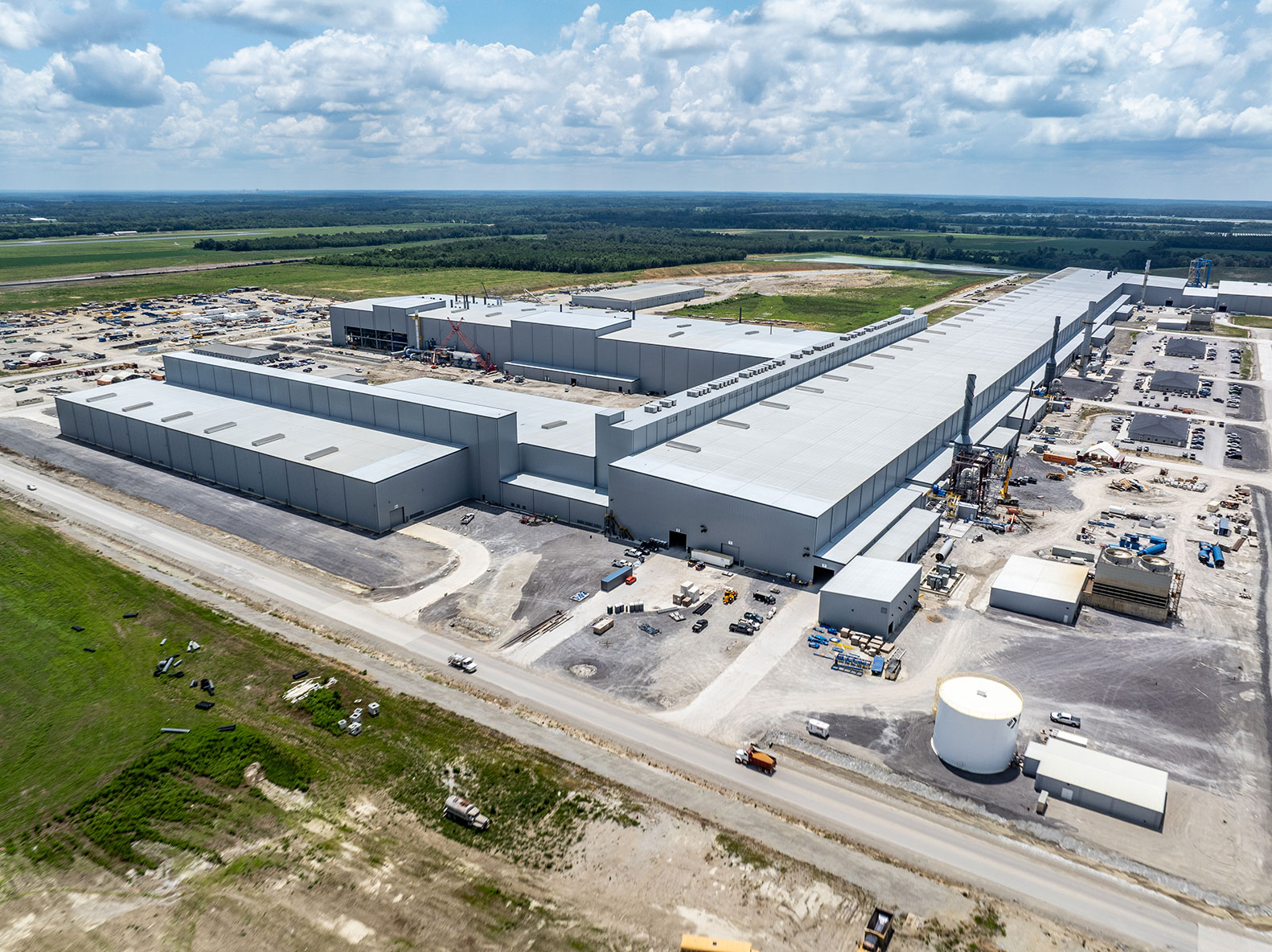 Aerial view of Steel Dynamics’ aluminum mill complex with large industrial buildings and surrounding construction areas